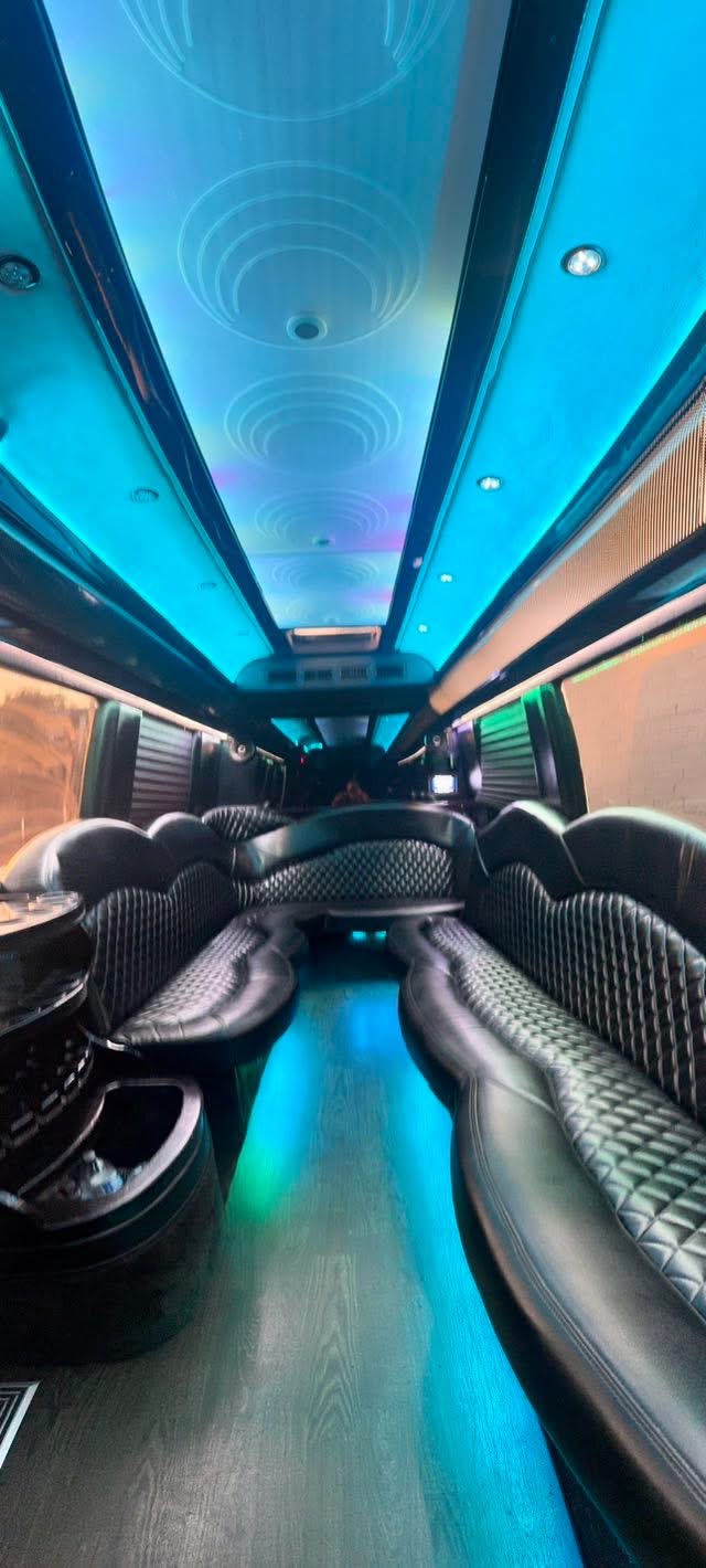 Luxury party bus interior with LED lighting and leather seating